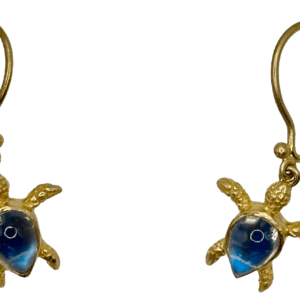 A pair of gold earrings with blue glass turtle charms.